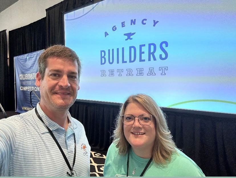 DuBose leadership (Blake and Julie) posing for a picture in front a presentation board that reads 